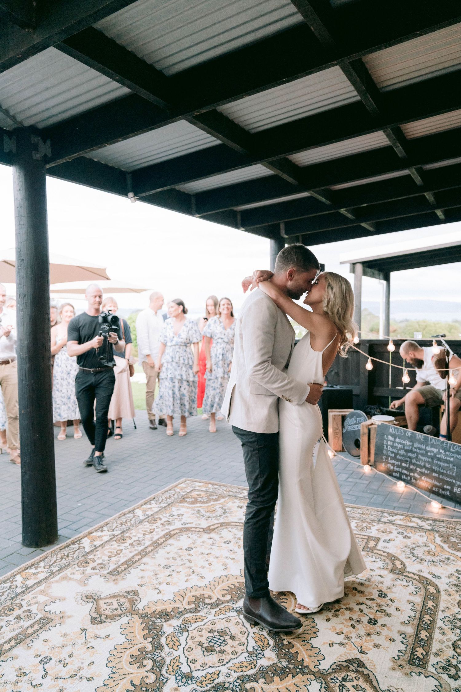 A romantic first dance moment under a covered patio at the wedding reception.