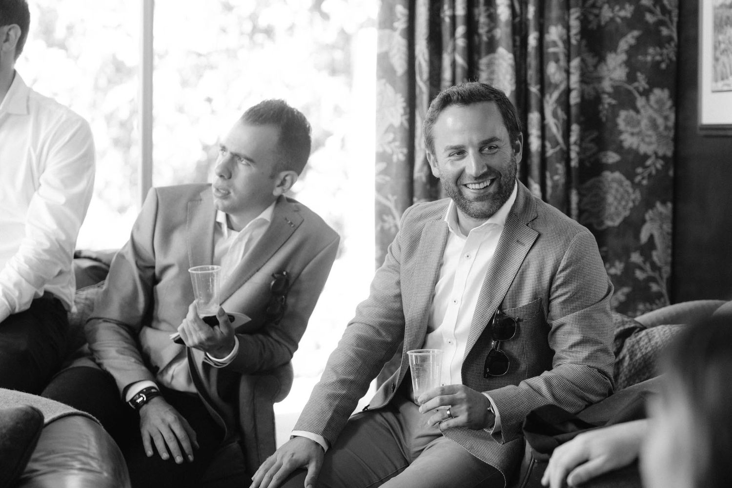 A black and white photo sequence showing candid reactions and laughter during what appears to be a casual gathering.