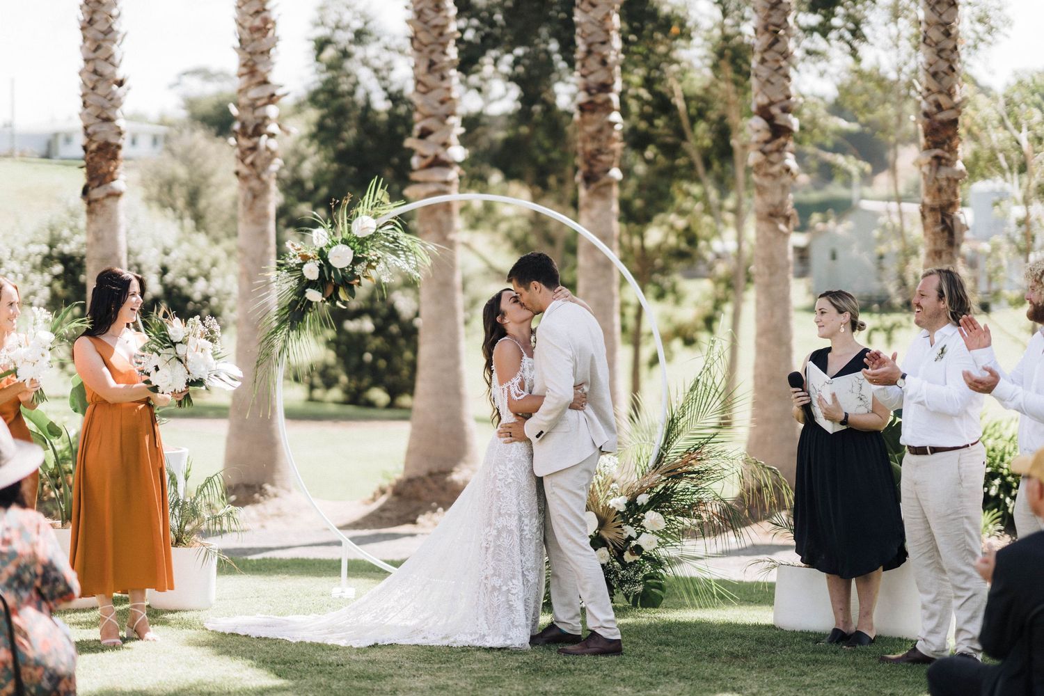 Candid moments from an outdoor wedding celebration under palm trees.