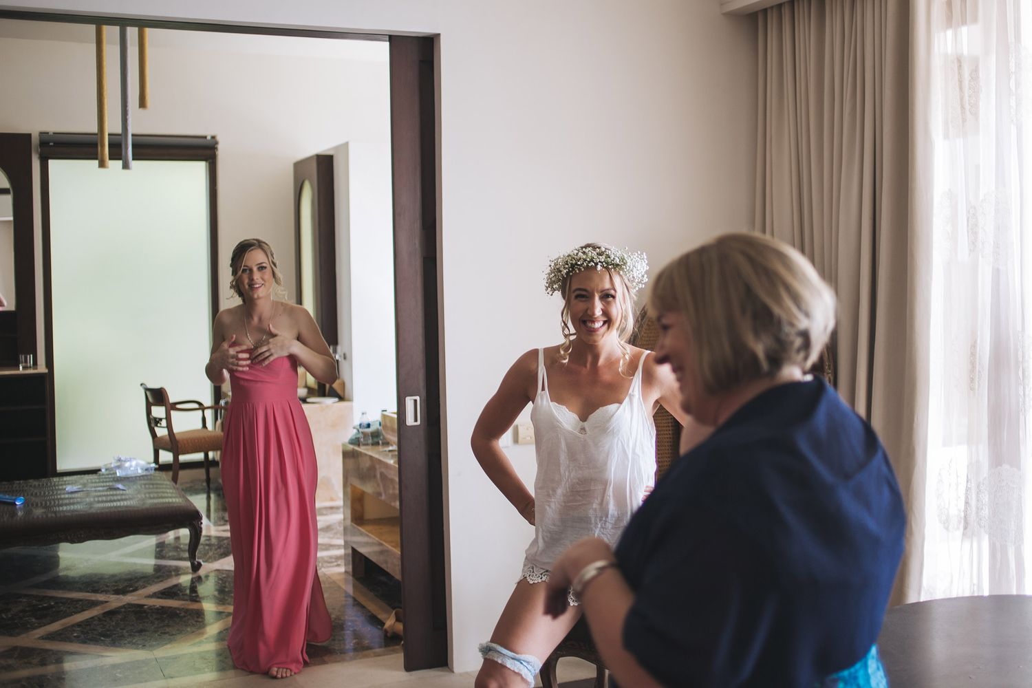 Getting ready scene with attendants in a hotel room.
