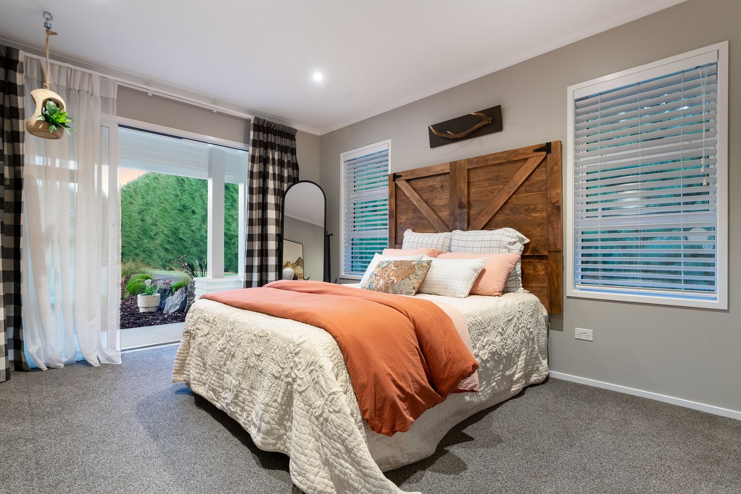 Modern bedrooms with neutral decor featuring plush bedding, window treatments, and coordinated color schemes.