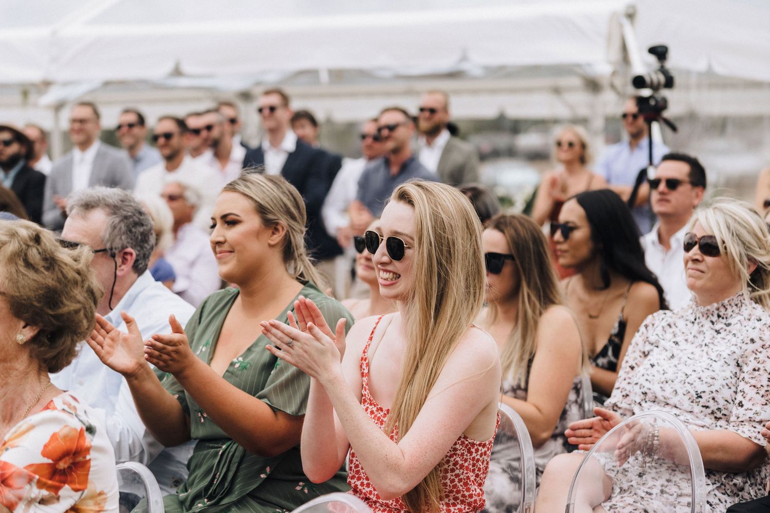 Wedding guests in summer attire enjoying an outdoor celebration.
