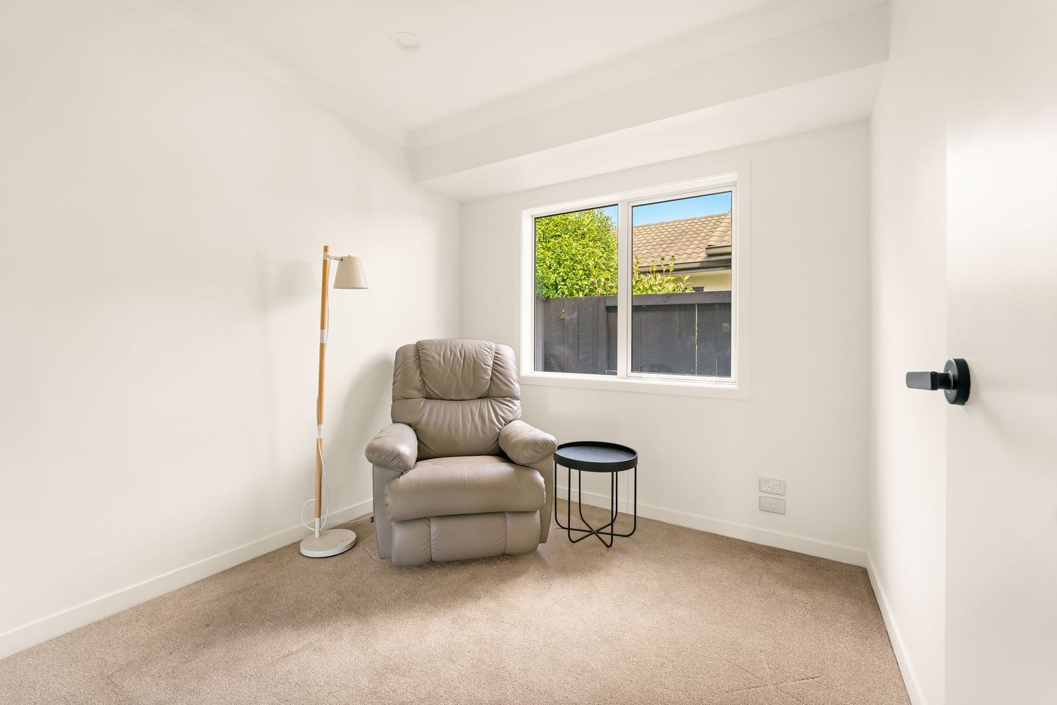 Minimalist interior spaces featuring white walls, hardwood floors and modern furnishings in a bright residential setting.