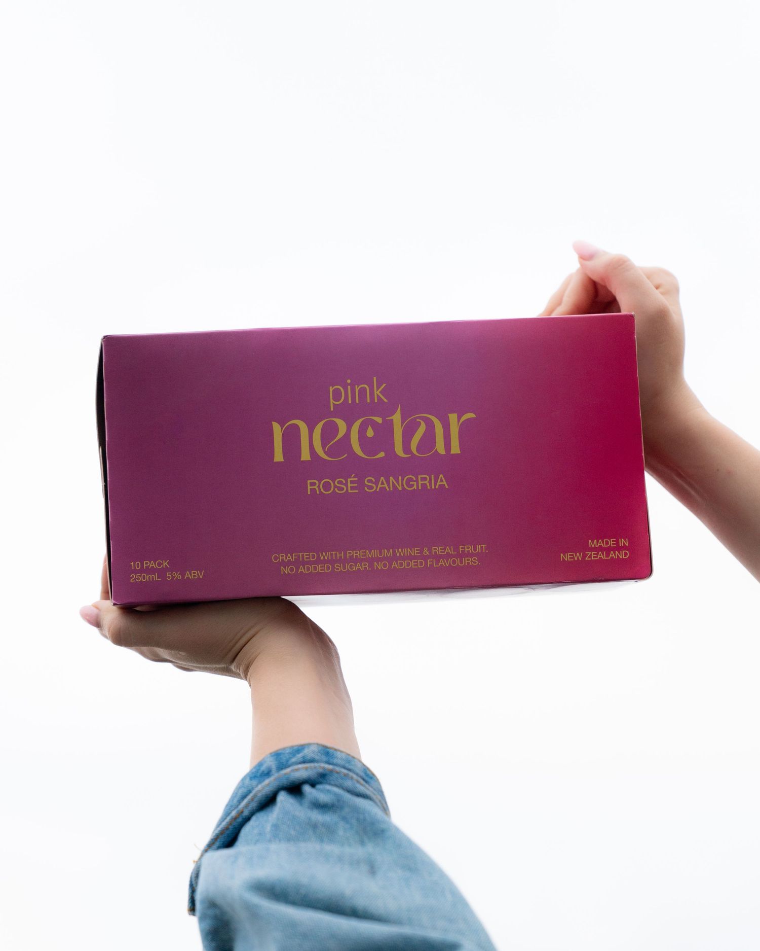 A purple box of Pink Nectar rose sangria held against a white background.