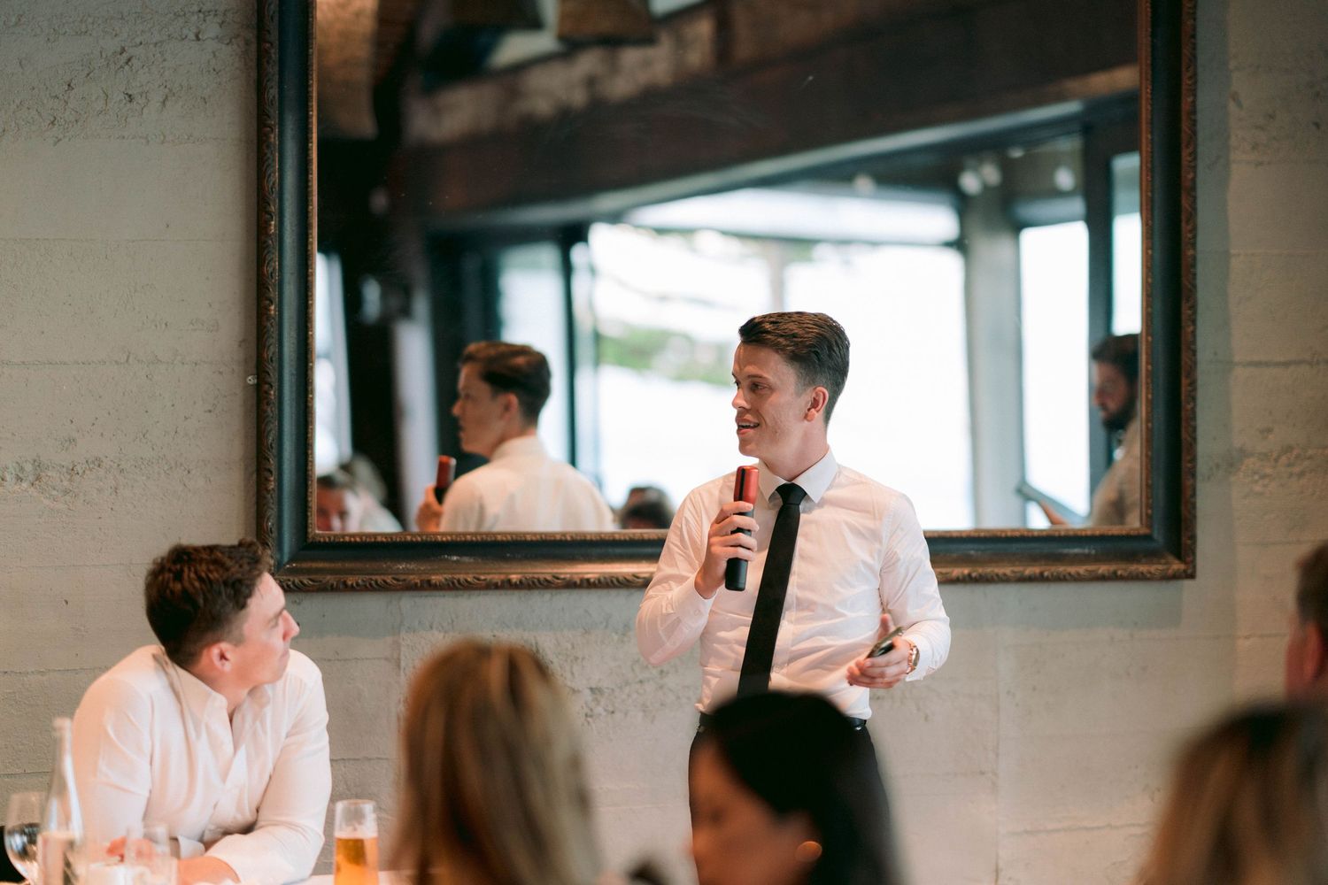 Indoor wedding venue with modern white decor and natural lighting.