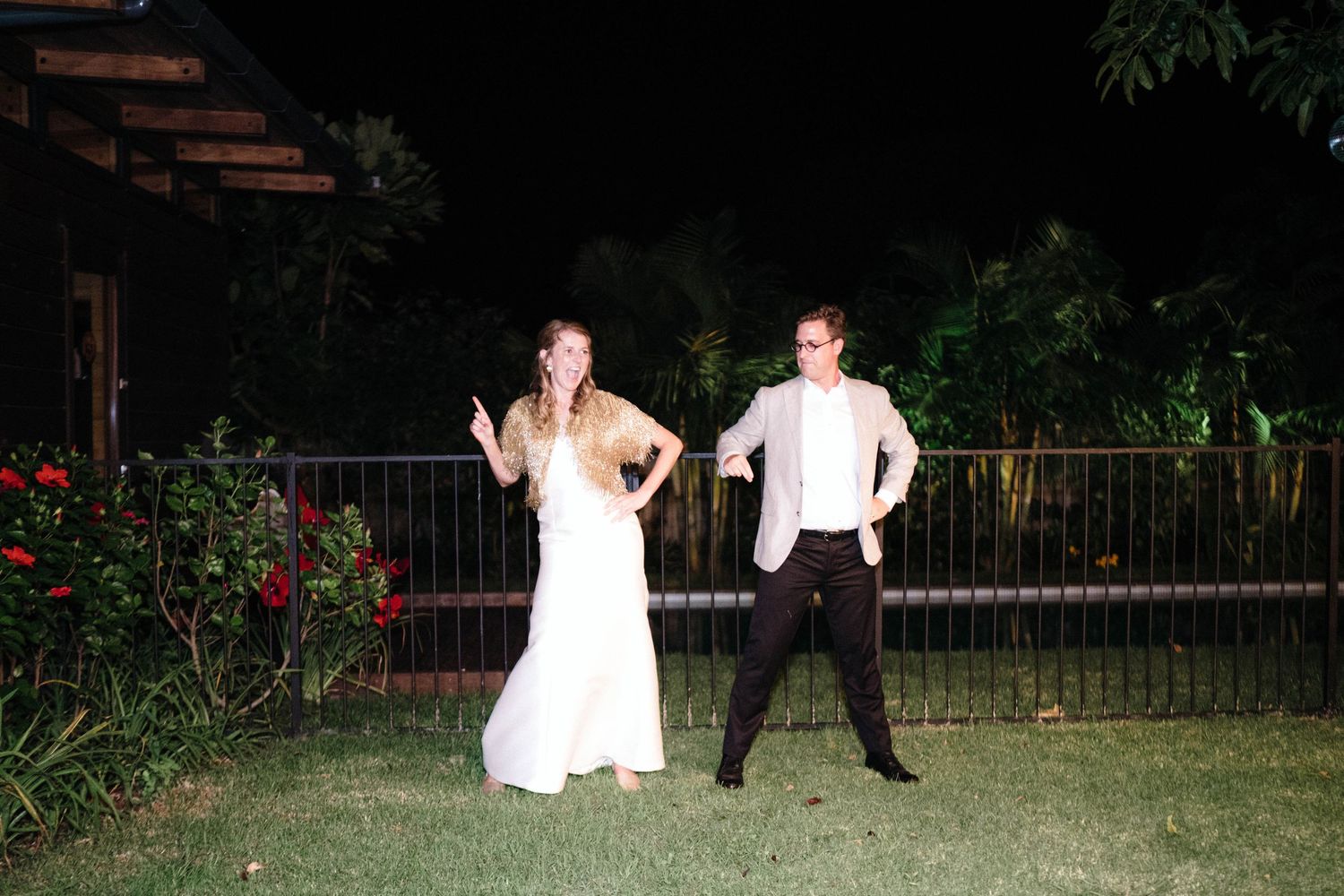 Couples dancing together on an outdoor patio at night.