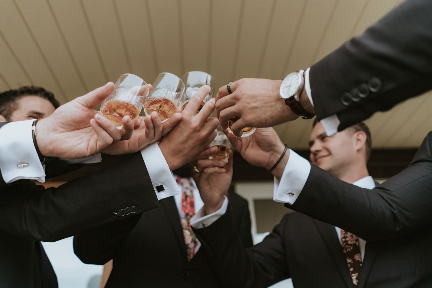 A group of business professionals toasting and clinking glasses during a celebration or gathering.