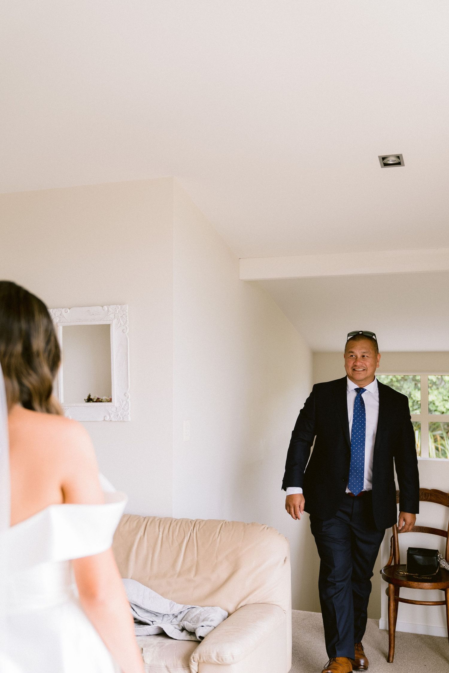 A couple sharing their first look moment before the wedding ceremony in a bright indoor setting.