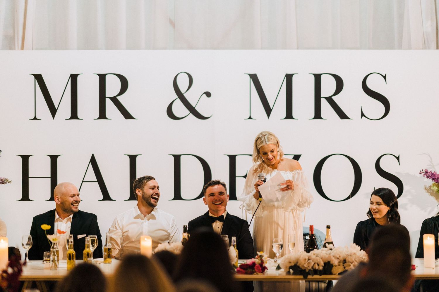 A wedding reception setup with 'MR & MRS' signage displayed prominently at the head table.