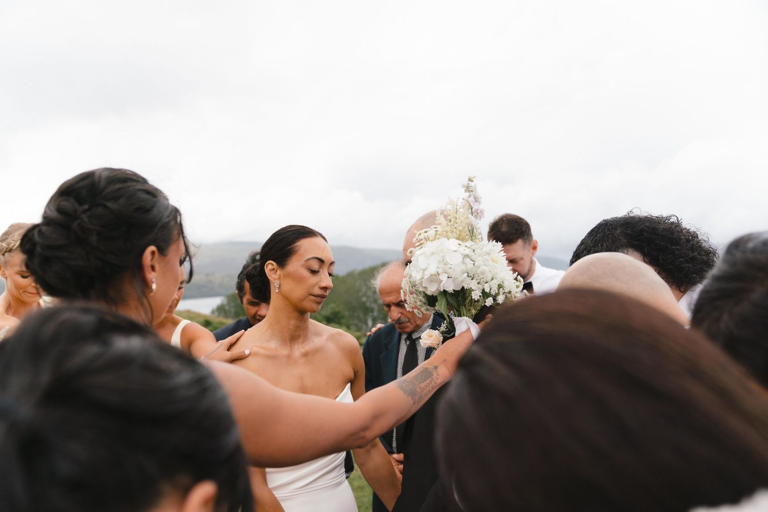 Intimate wedding moments captured in black and white photography showing guests celebrating at a seaside venue.