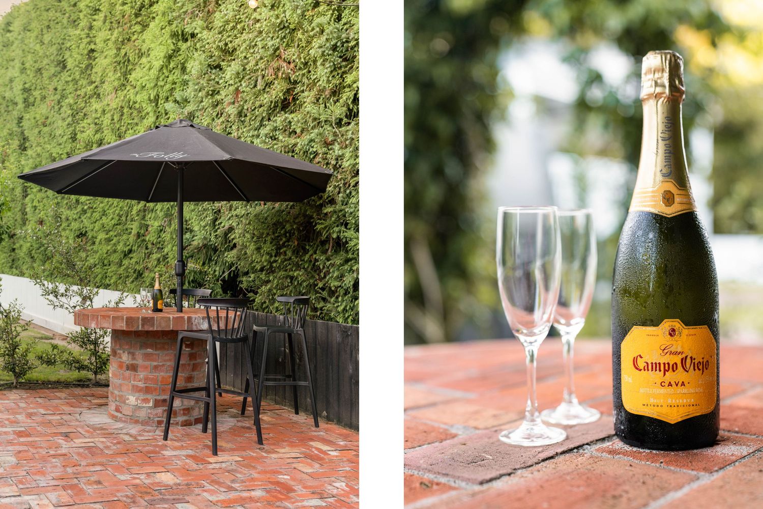 Outdoor setting with black umbrella and bistro table alongside champagne bottle with glasses.
