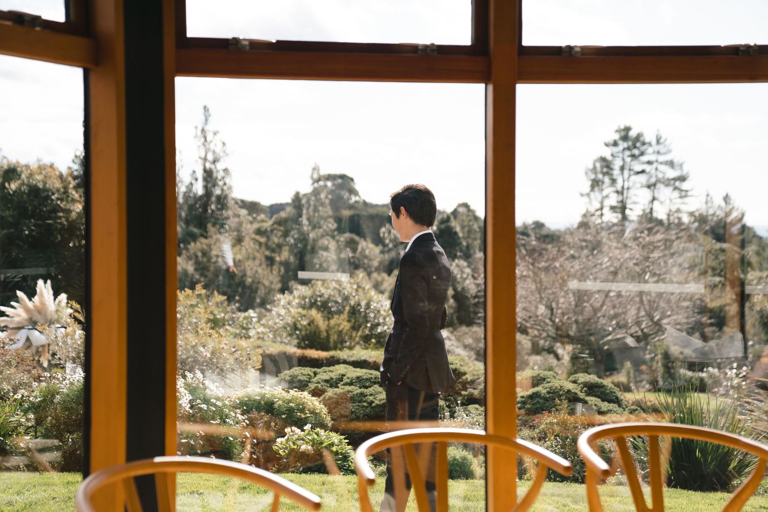 Large panoramic windows in a modern home offering sweeping views of rural countryside and distant mountains.