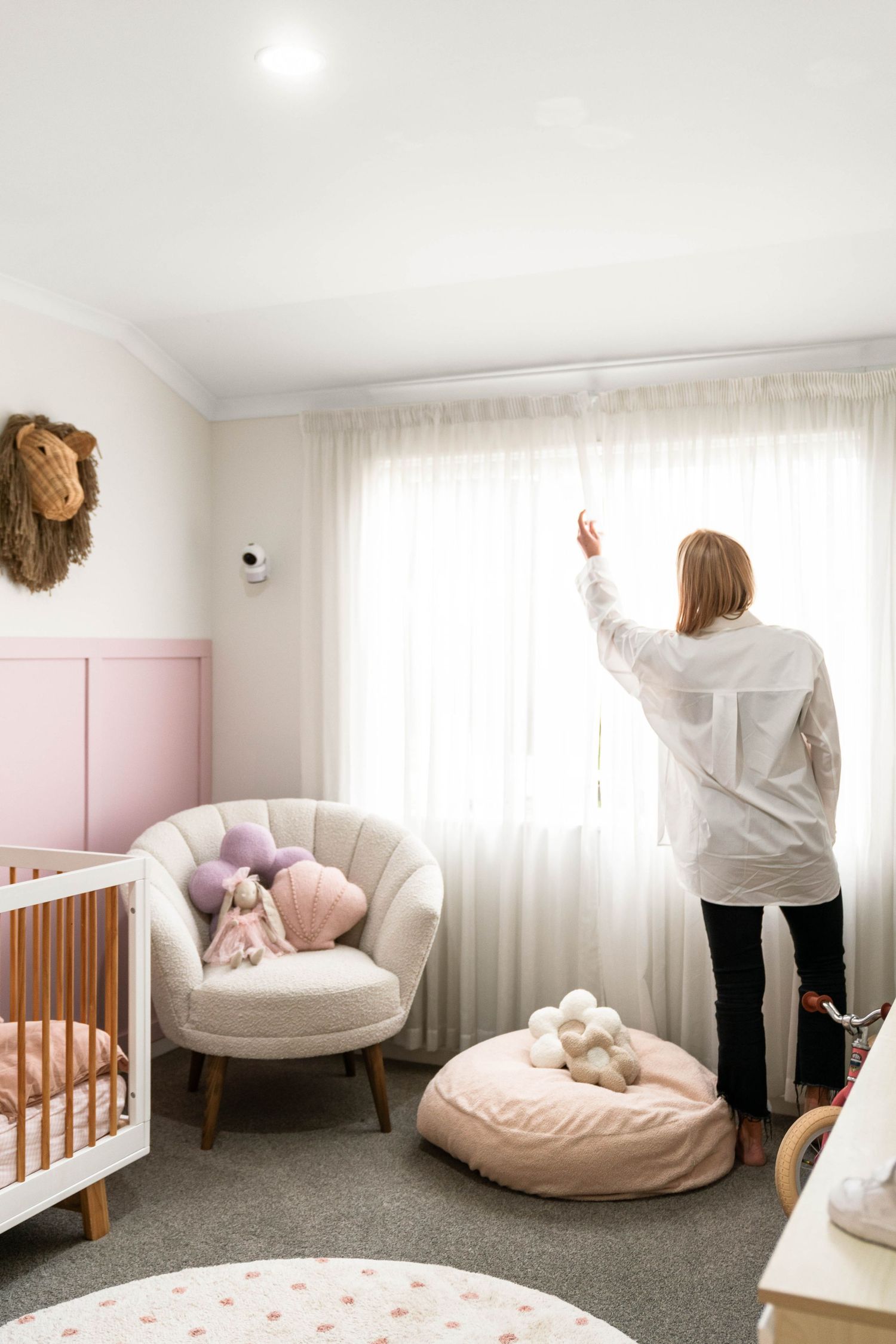 A sequence of images showing a pastel-colored nursery room with a white round chair and wooden crib.