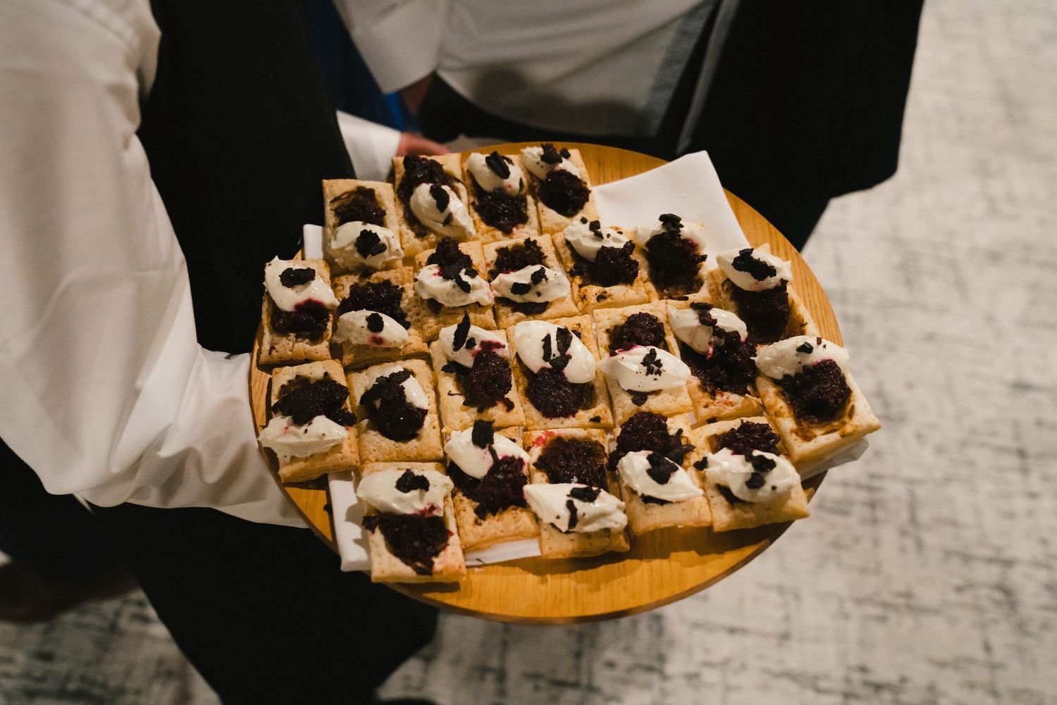 Overhead view of dessert bites arranged on an orange serving platter.