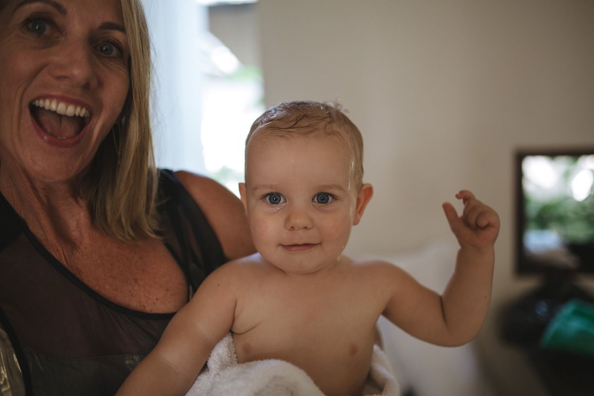 A heartwarming family scene with parents playing together with a baby in an indoor setting.
