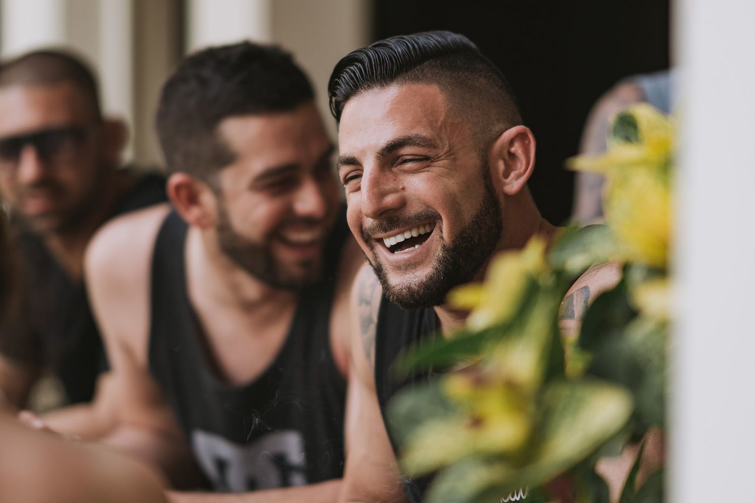Group of friends sharing a cheerful moment and laughing together outdoors.