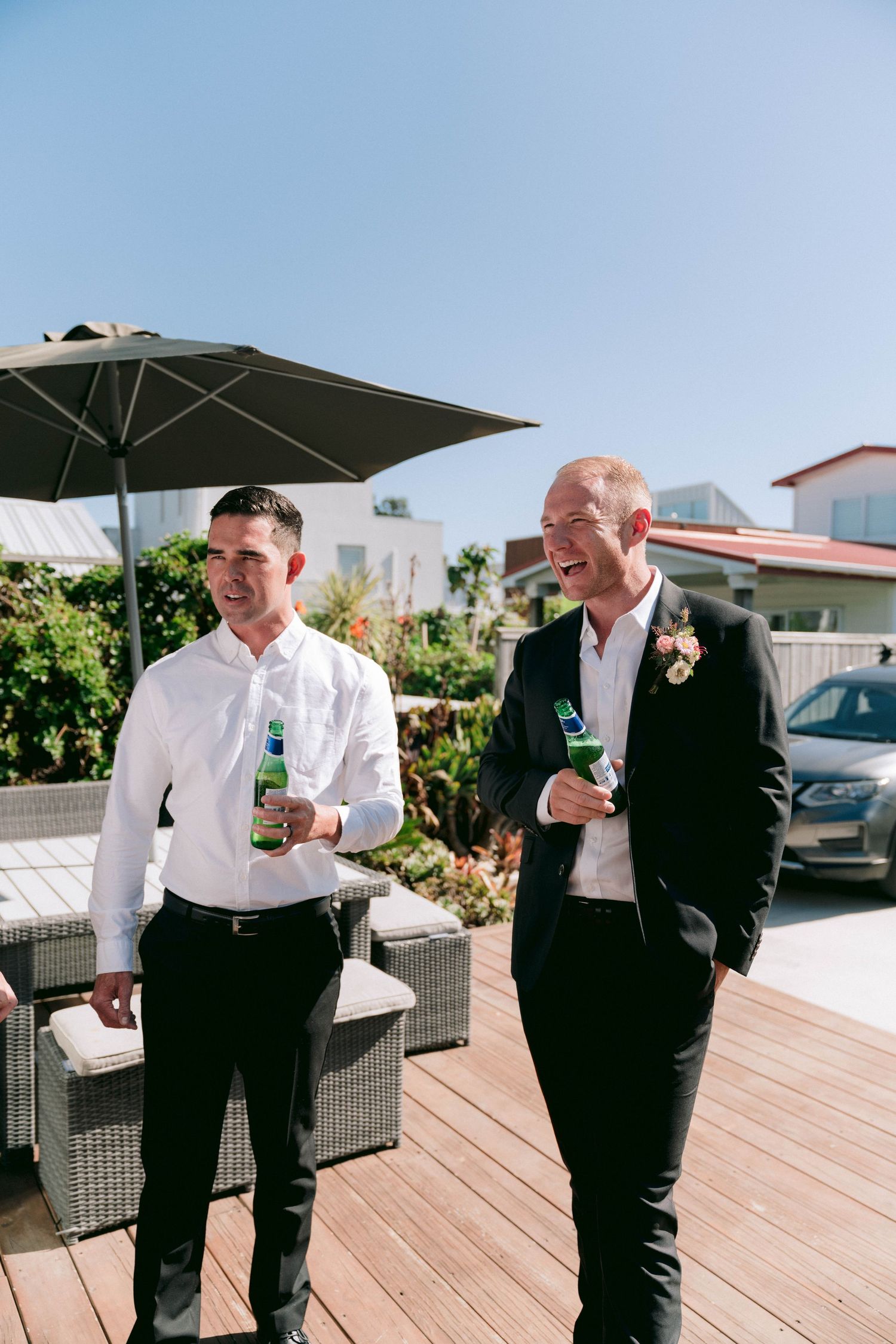 A series of candid moments showing groomsmen relaxing on an outdoor deck with drinks.
