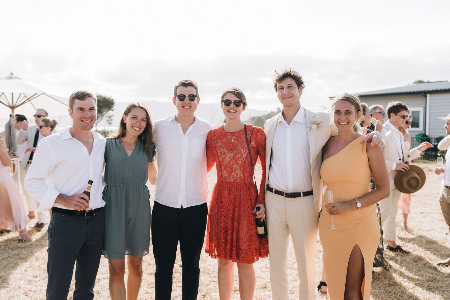 A group of people in casual summer attire enjoying time together at an outdoor event or gathering.