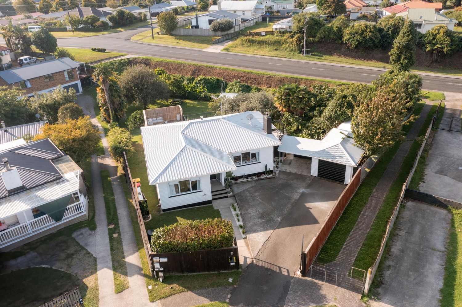Birds-eye perspective of a residential neighborhood showing houses, driveways and well-maintained yards.