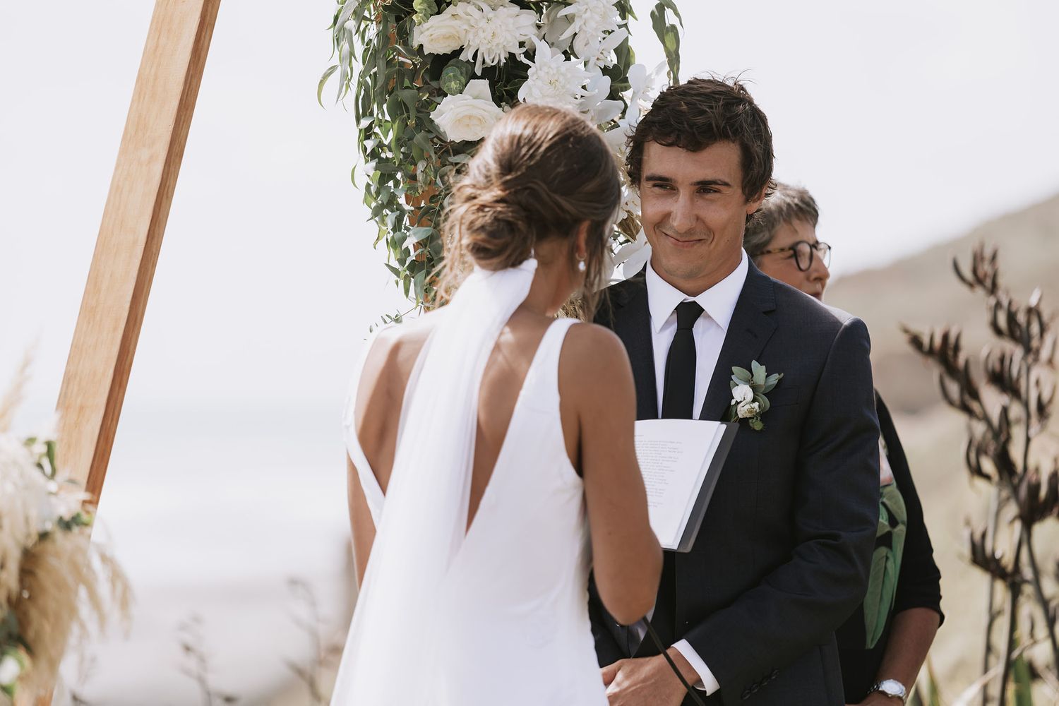 Candid wedding photo series showing the happy couple in various romantic poses during their outdoor ceremony.