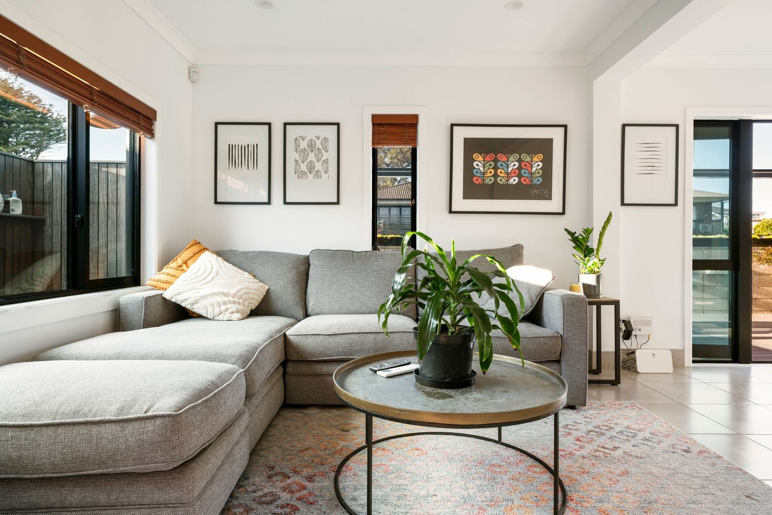 Minimalist modern interior design featuring white walls, artwork, and contemporary furniture.