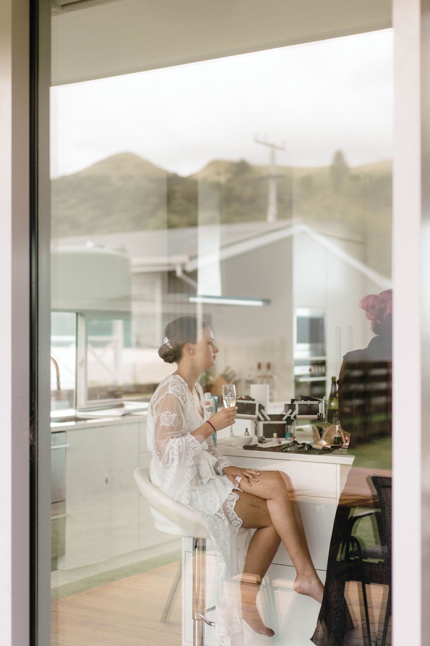 Elegant interior of modern venue with glass walls and scenic mountain views in background.