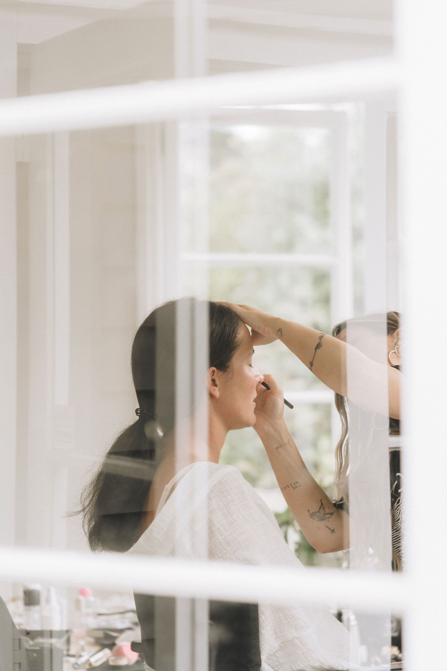 Behind-the-scenes preparation moments in a bright, white-walled room during a special event.