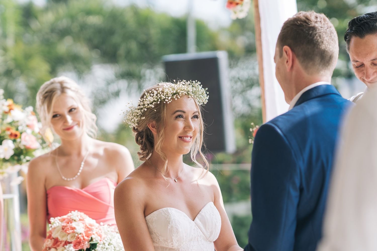 A series of first look photos showing tender wedding moments in a light-filled setting with floral decor.