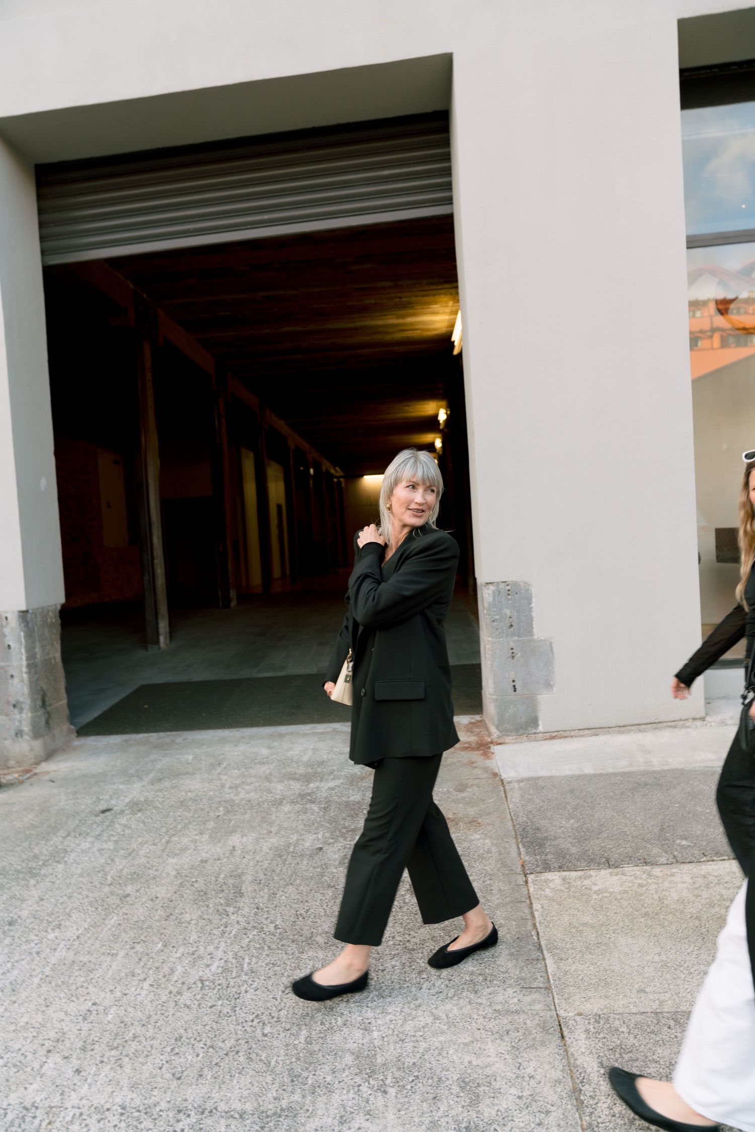 A sequence of photos shows a person in black clothing gradually disappearing into a dark parking garage entrance.