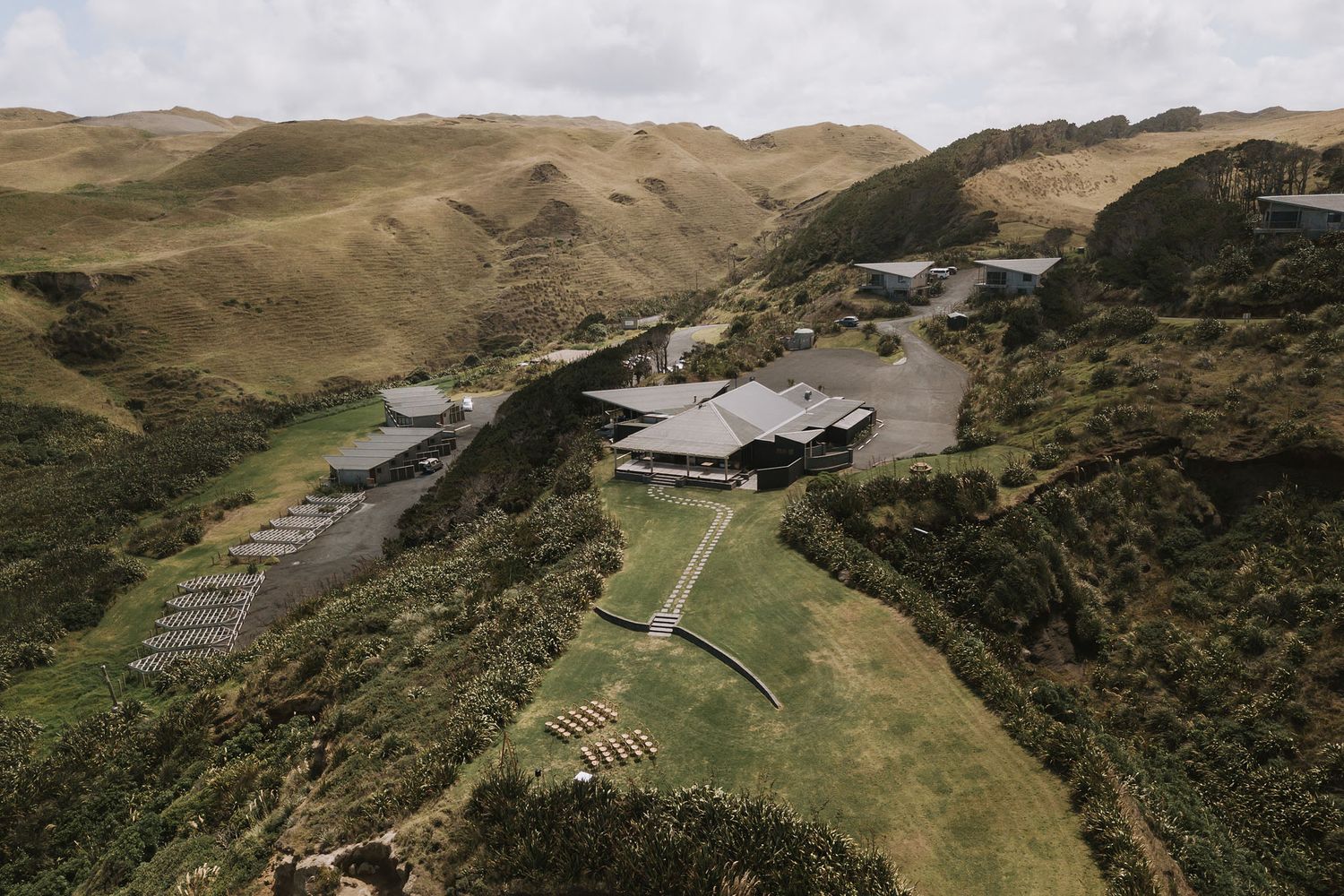Aerial panoramic view of lush green mountain landscapes with agricultural fields and terraced hills stretching to the horizon.