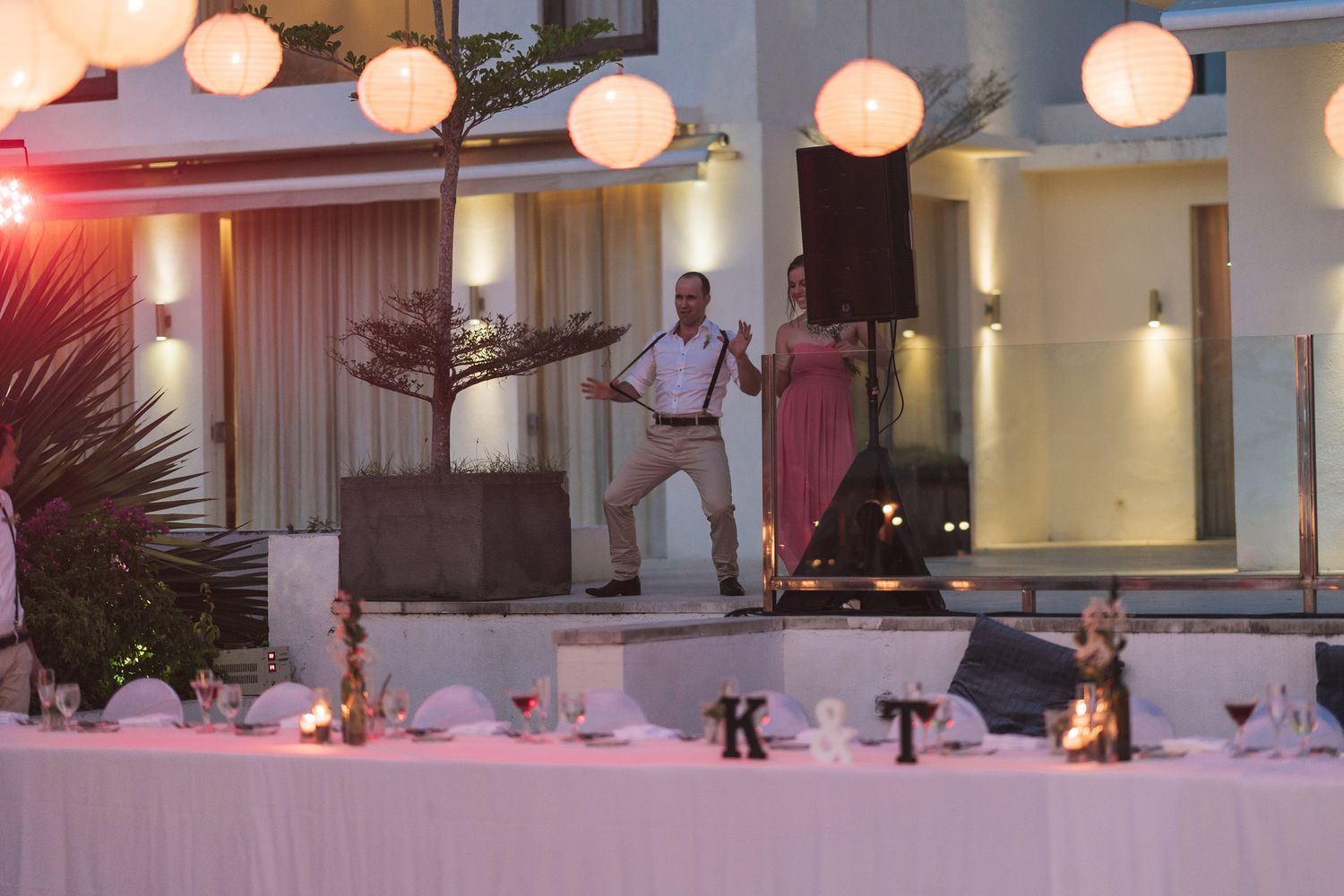 Reception venue decorated with paper lanterns and ambient lighting at dusk.