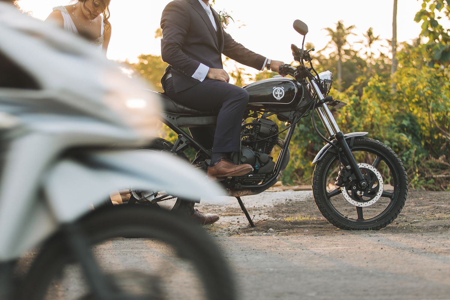Wedding photography featuring vintage motorcycles parked in a scenic outdoor setting.