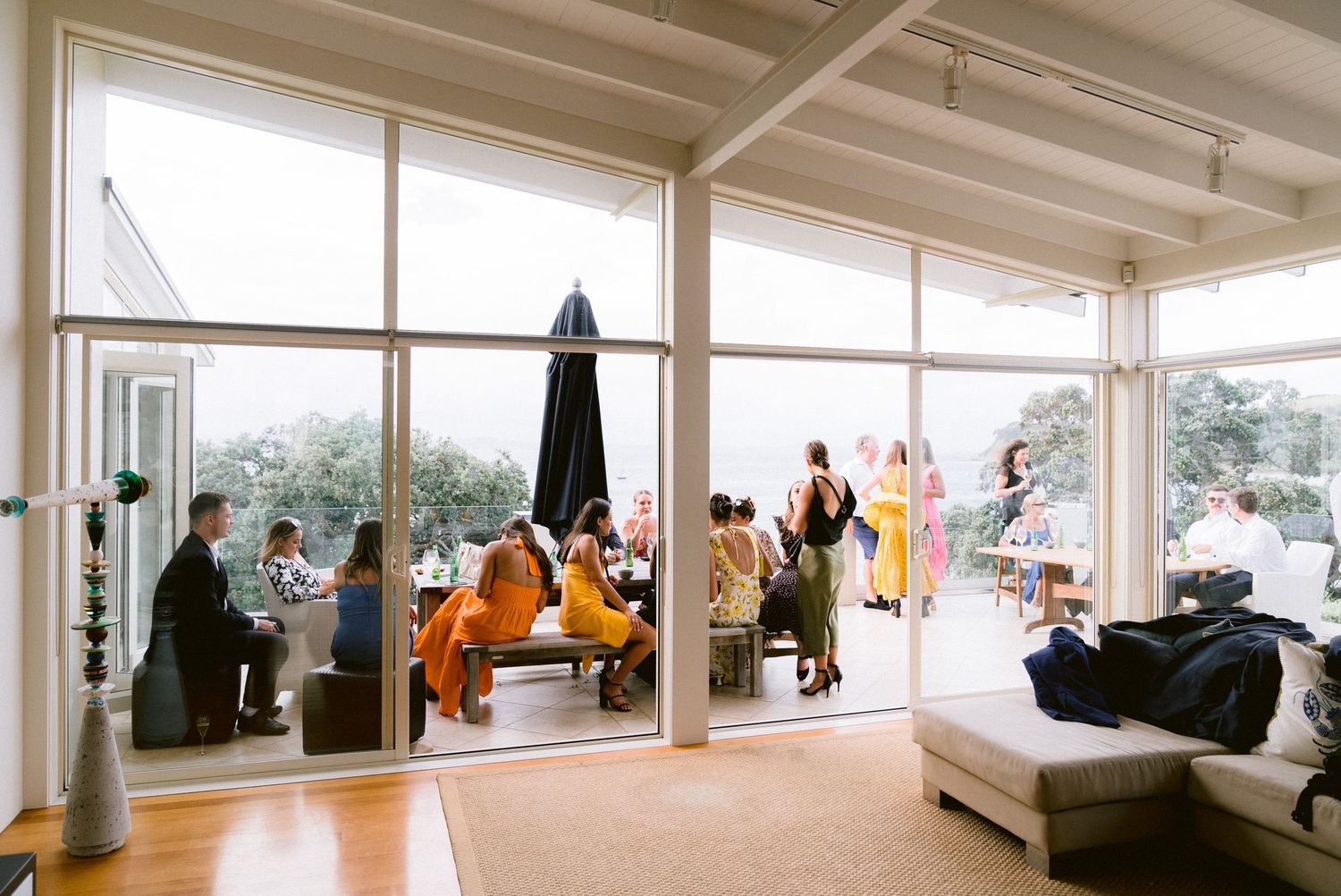 Bright indoor venue with large windows showing panoramic coastal views.