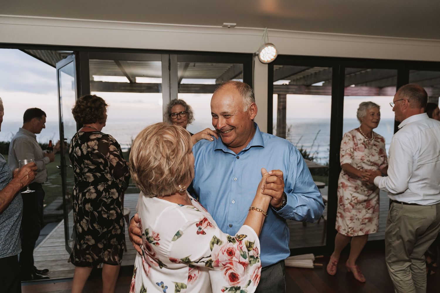 Couples dancing together at an elegant evening reception with warm lighting and festive atmosphere.
