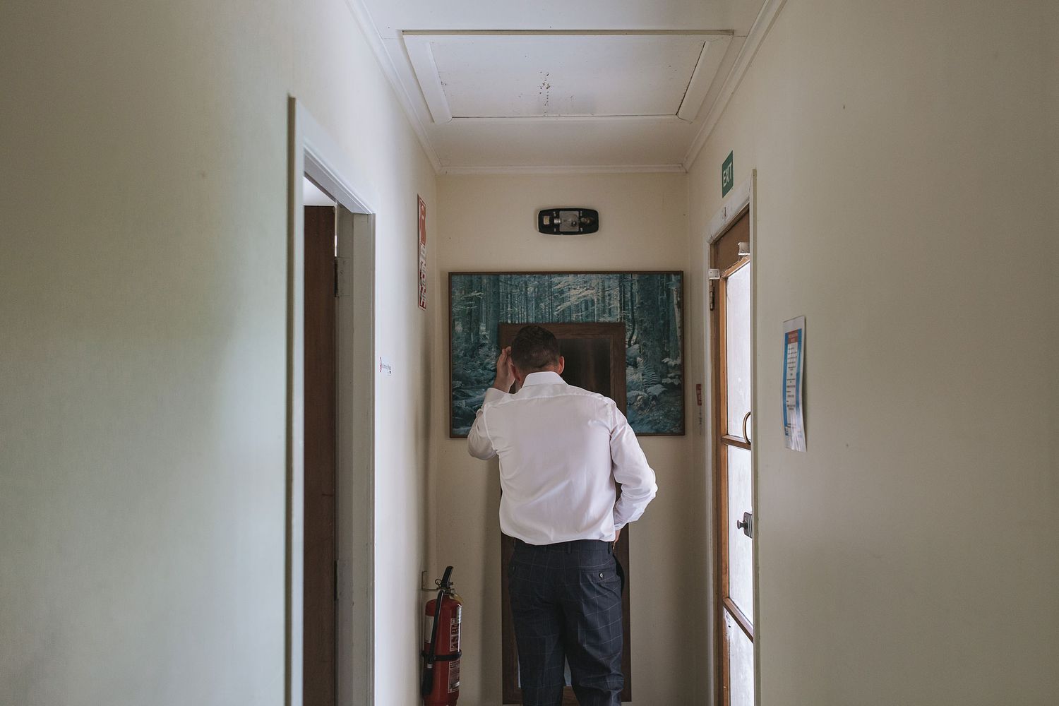 Empty beige hallway with white trim and doors displaying simple interior residential architecture.