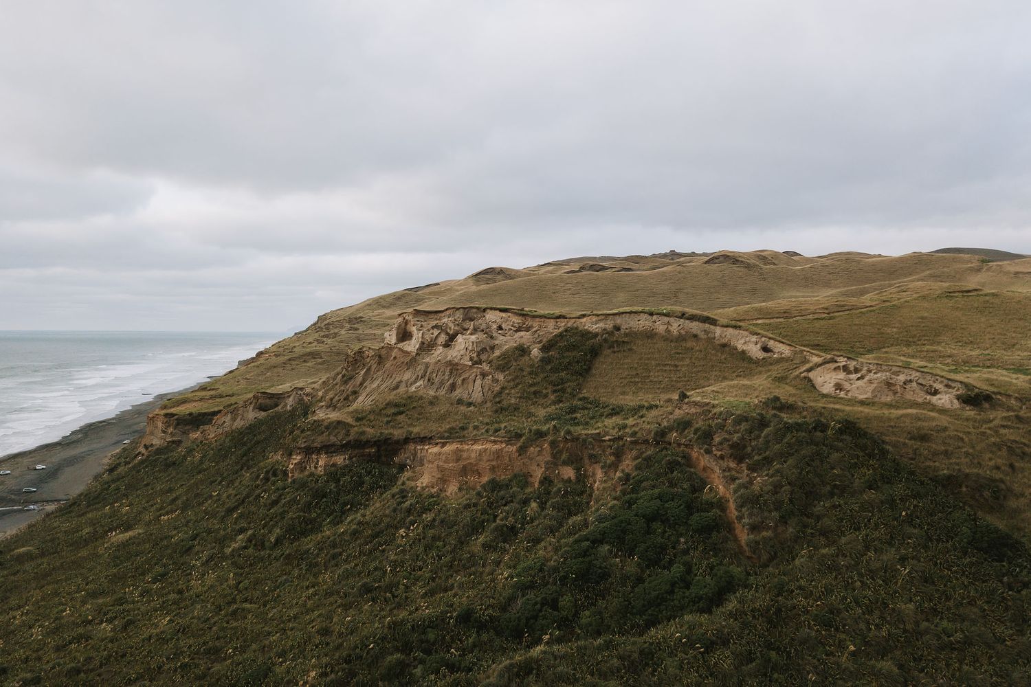 Seven scenic images of rolling green hills and rugged coastal landscapes show dramatic natural terrain under moody skies.