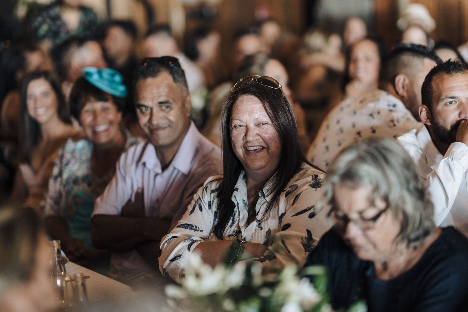 Wedding guests enjoying entertainment and festivities in a warm, intimate indoor setting.