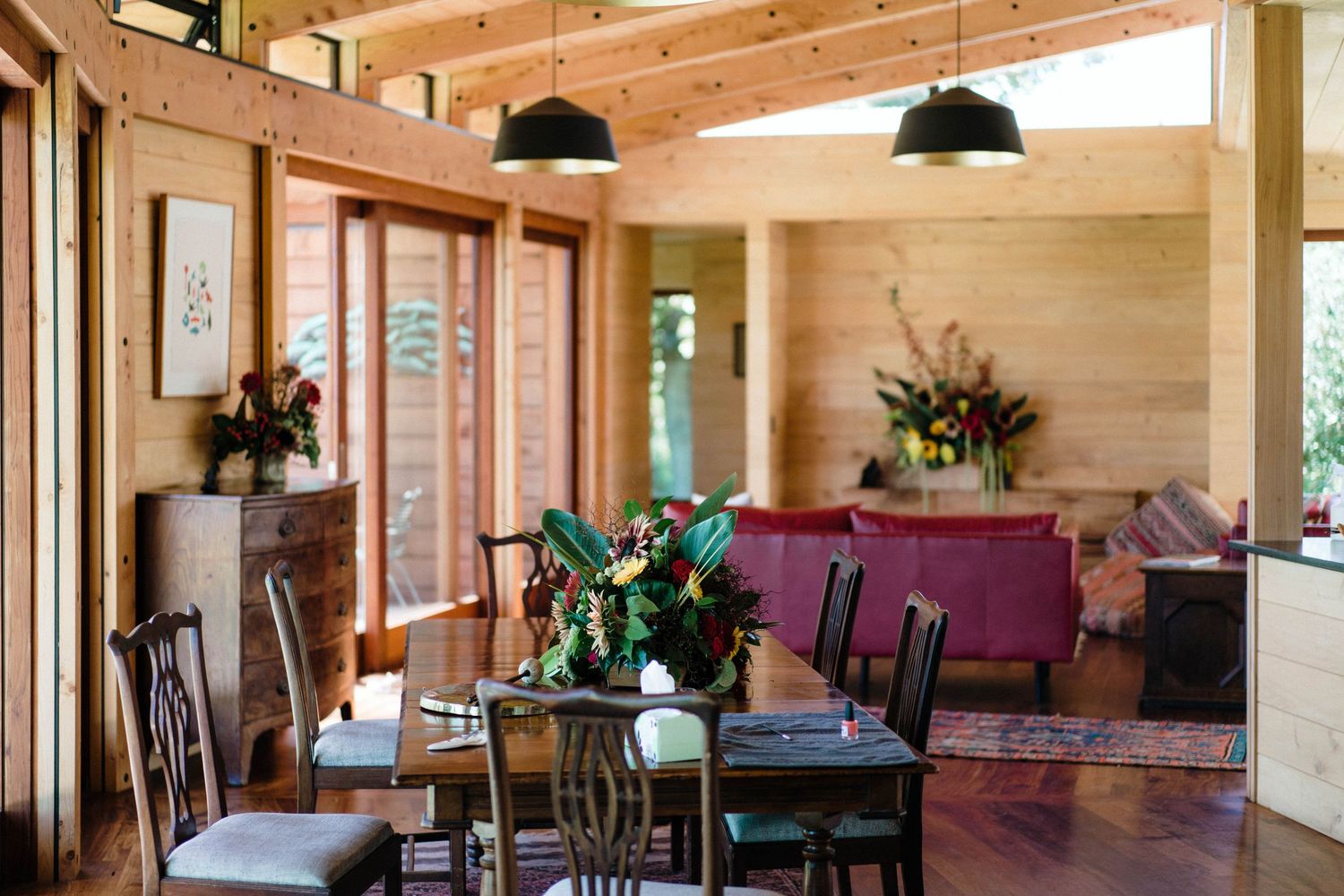 Spacious wooden interior venue with exposed beams and purple accent furniture.