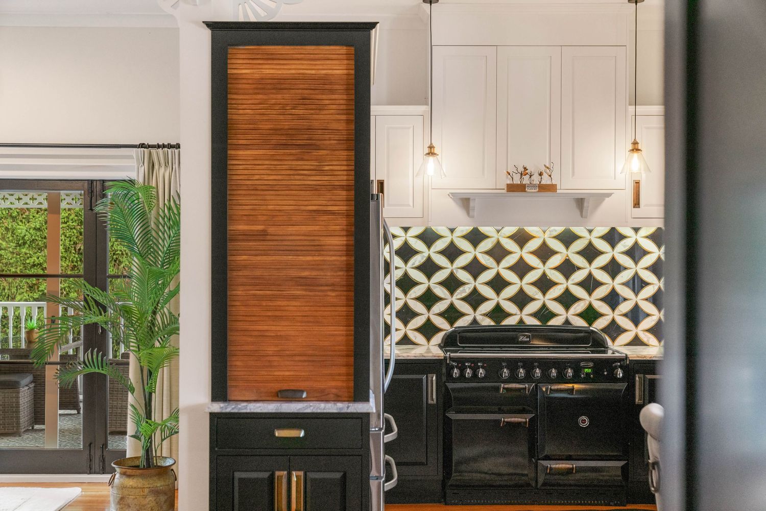 Stylish kitchen featuring black cabinetry, wooden accents, and lattice pattern details.