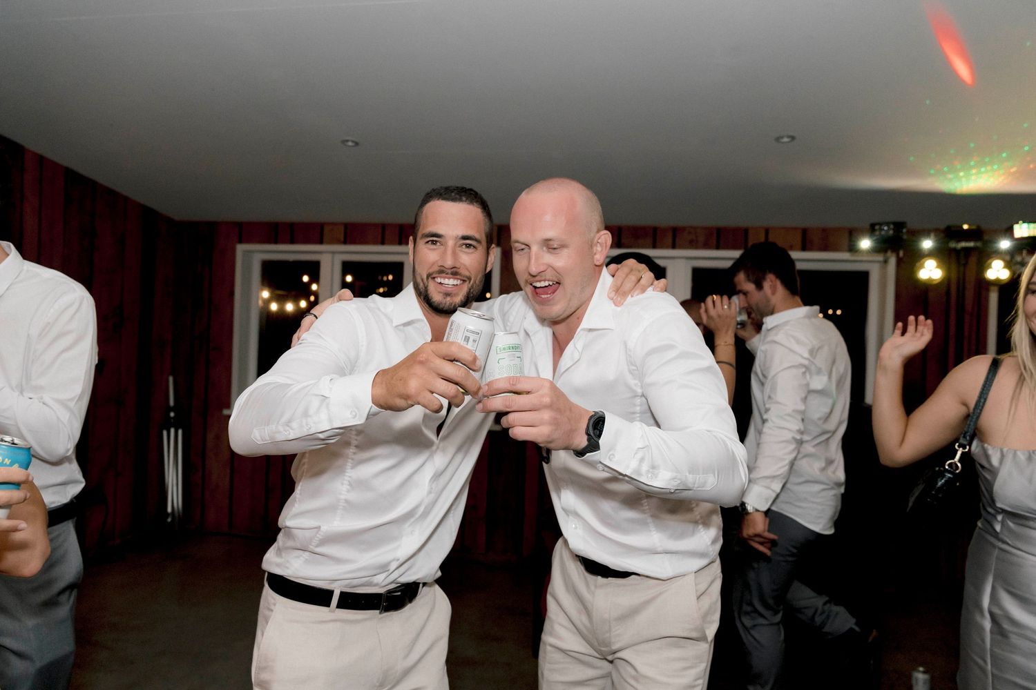 Wedding reception celebration with guests dancing in formal attire.