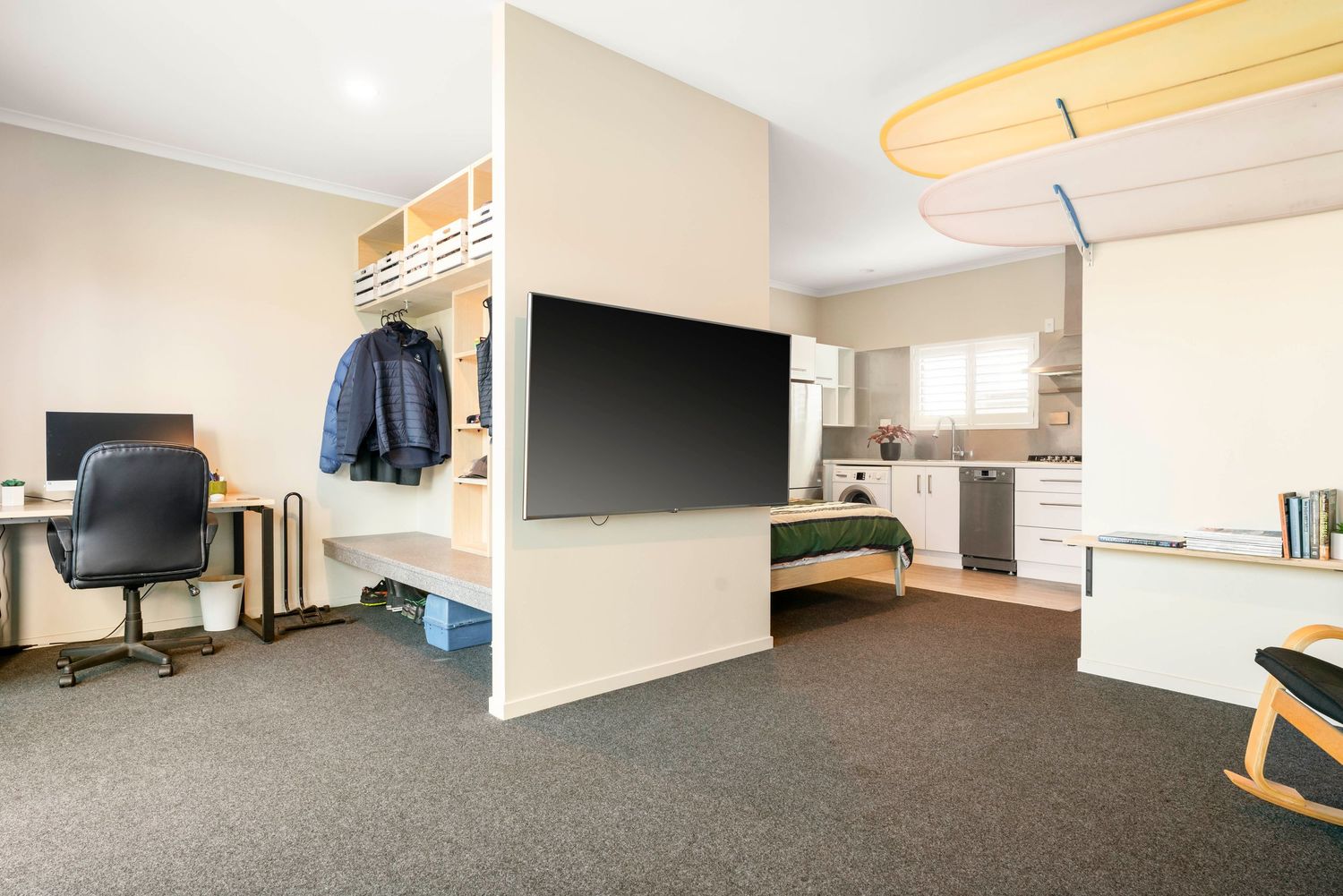 Spacious bedroom with carpeted flooring and large windows offering natural light.