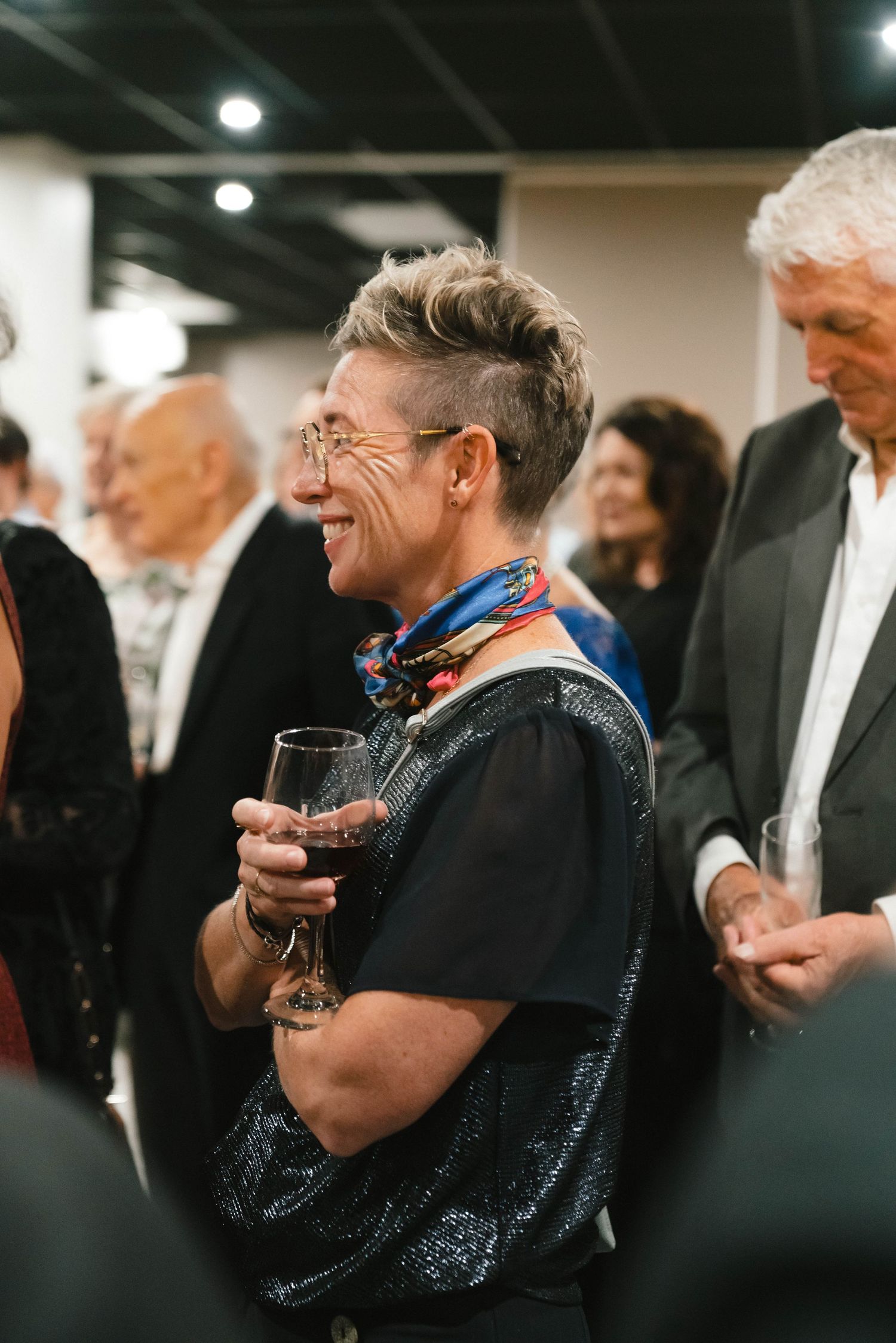 Guests enjoying drinks and conversation at an elegant evening social gathering.