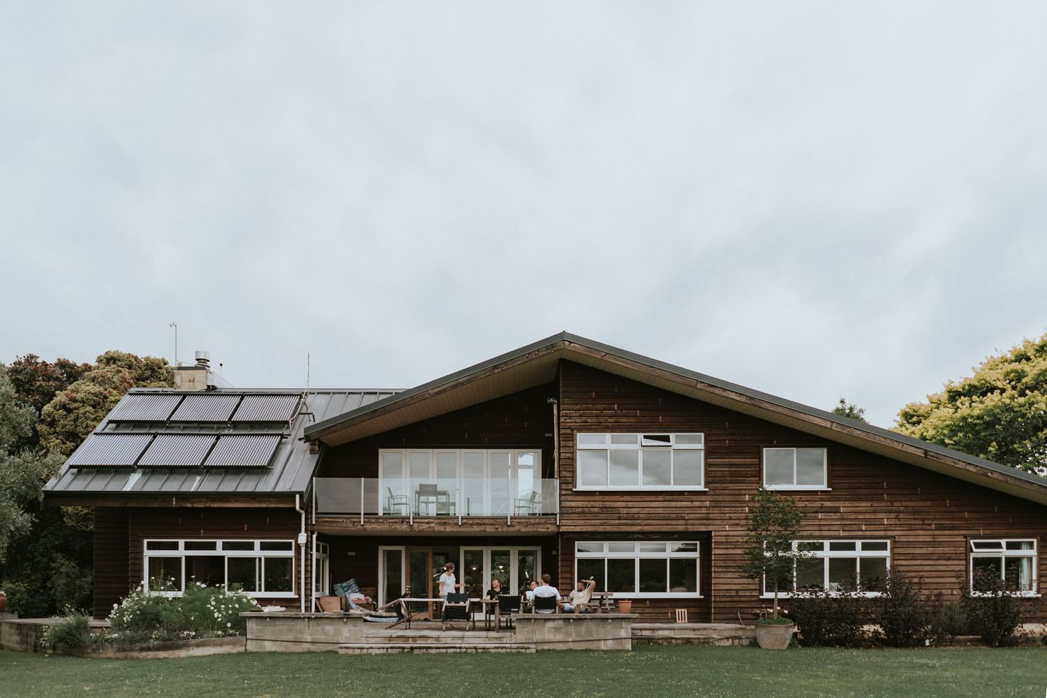 Five views of a modern ranch-style building with wood accents and large windows showcasing its architectural design in natural light.