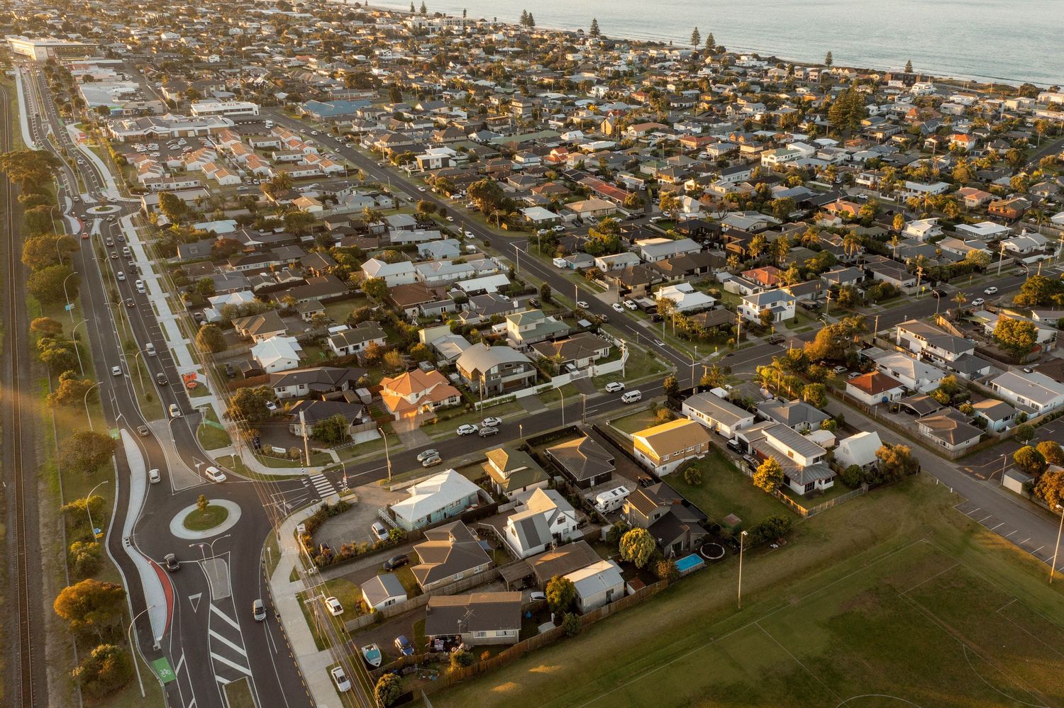 Bird's eye view of residential area with roundabout and dense housing development.