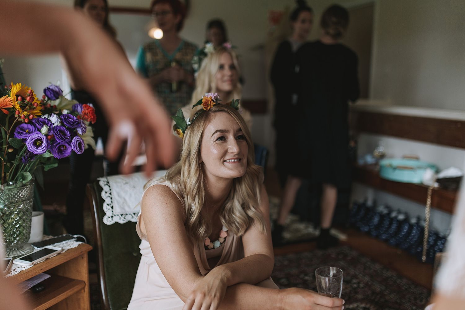 A group of people gather indoors at what appears to be a festive celebration or party in a casual setting.