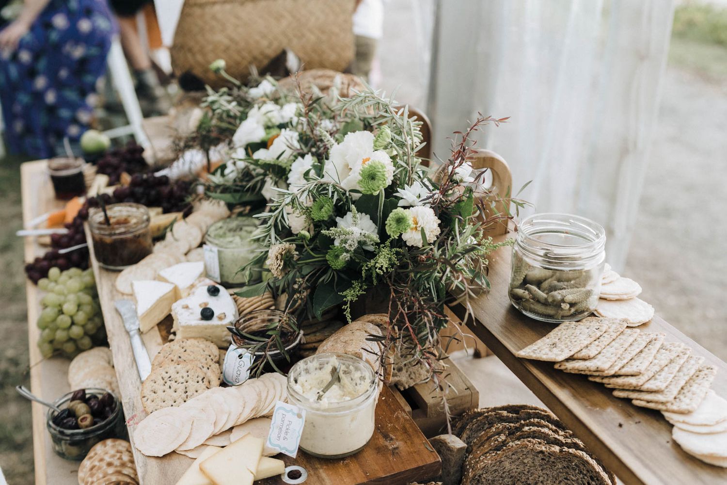 Rustic wedding table decor with white floral arrangements, burlap accents and vintage style table settings.