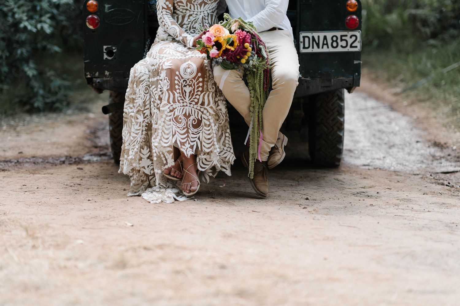 A joyous outdoor wedding ceremony features everyone holding sparklers to celebrate the happy couple's special moment.