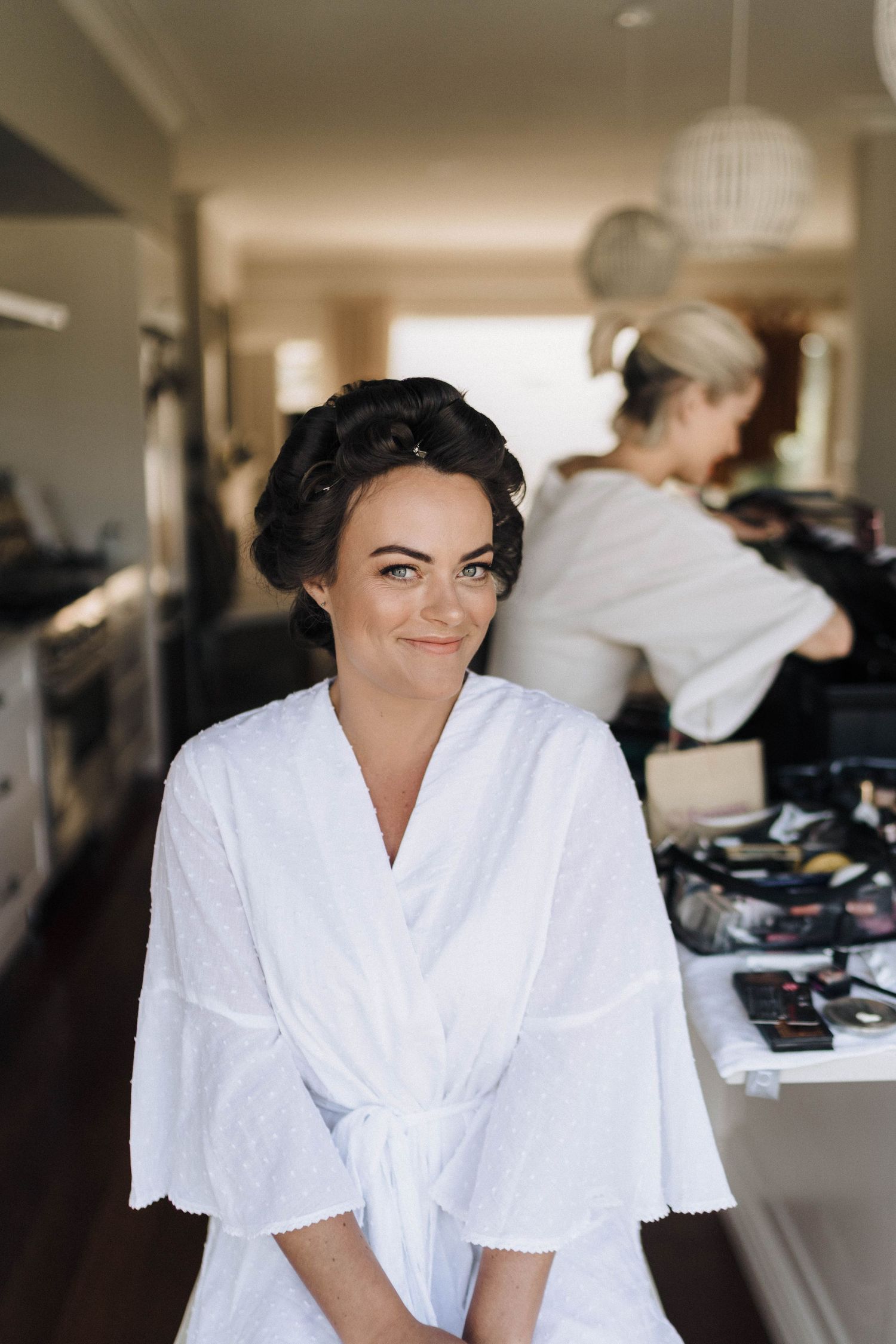 Getting ready in white robes during wedding day preparations.