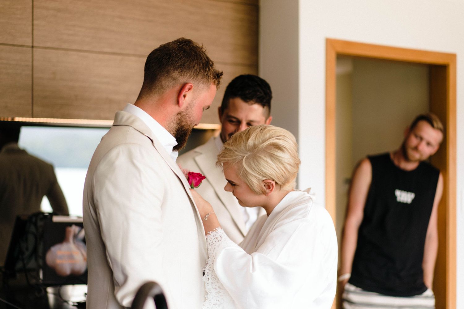 Emotional candid moment during wedding preparation in modern interior setting.