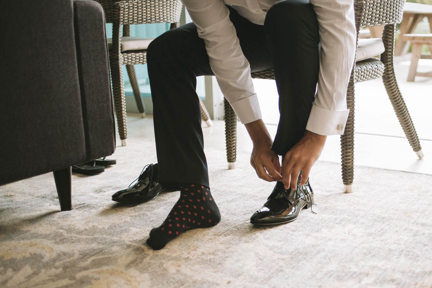 Close-up view of formal dress shoes and oxford-style footwear arranged in a row on a light-colored floor.